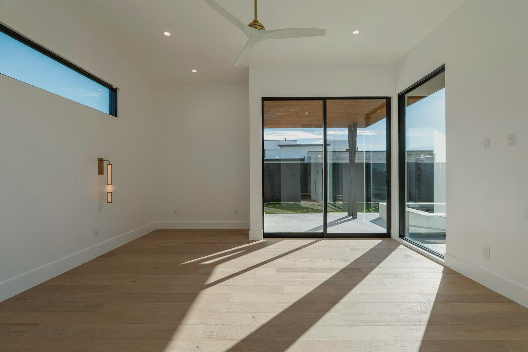 An empty room with a finished light oak floor